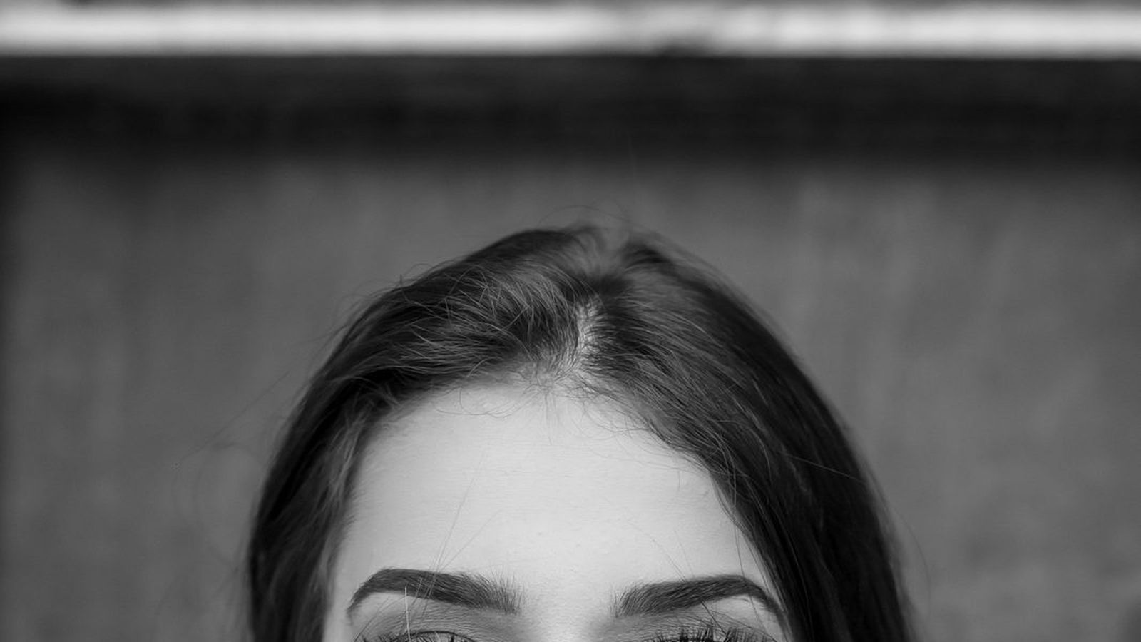 A close-up black and white portrait of a woman