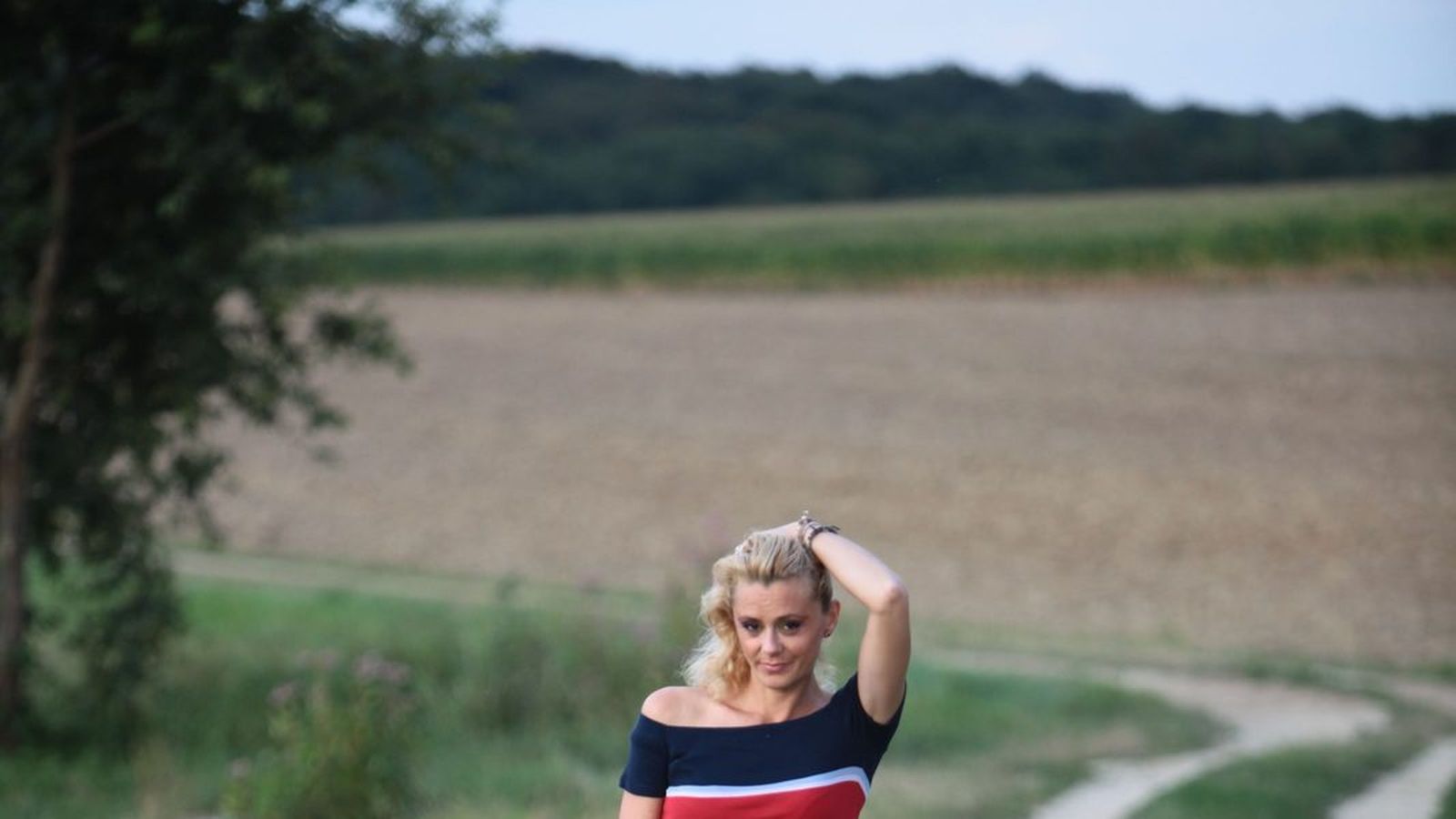 A woman walking along a countryside path