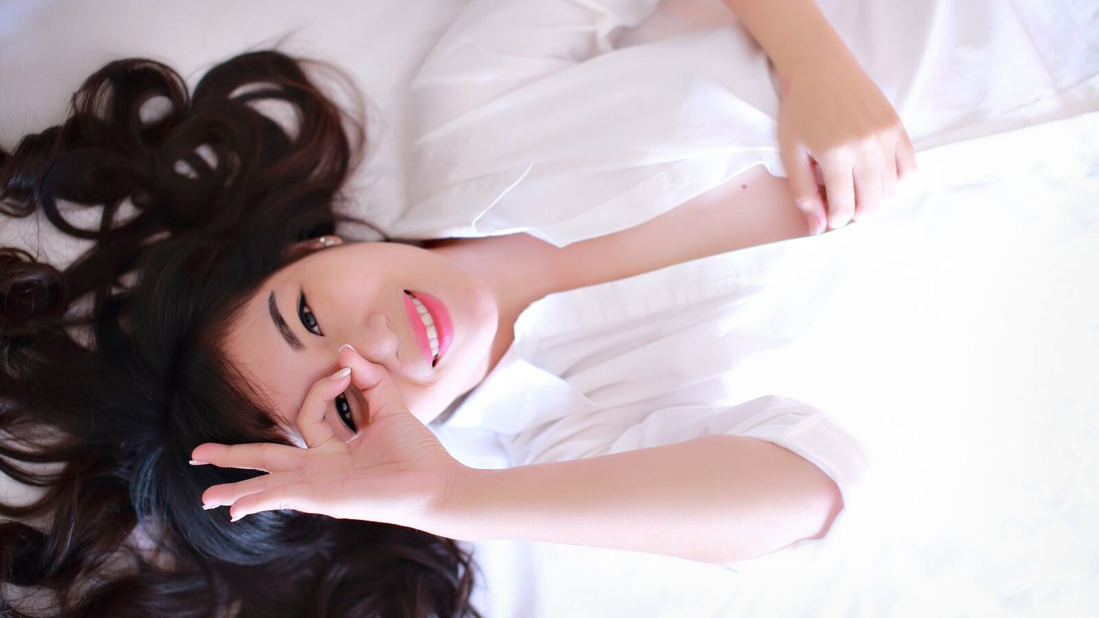 A woman in a white shirt in a relaxed setting