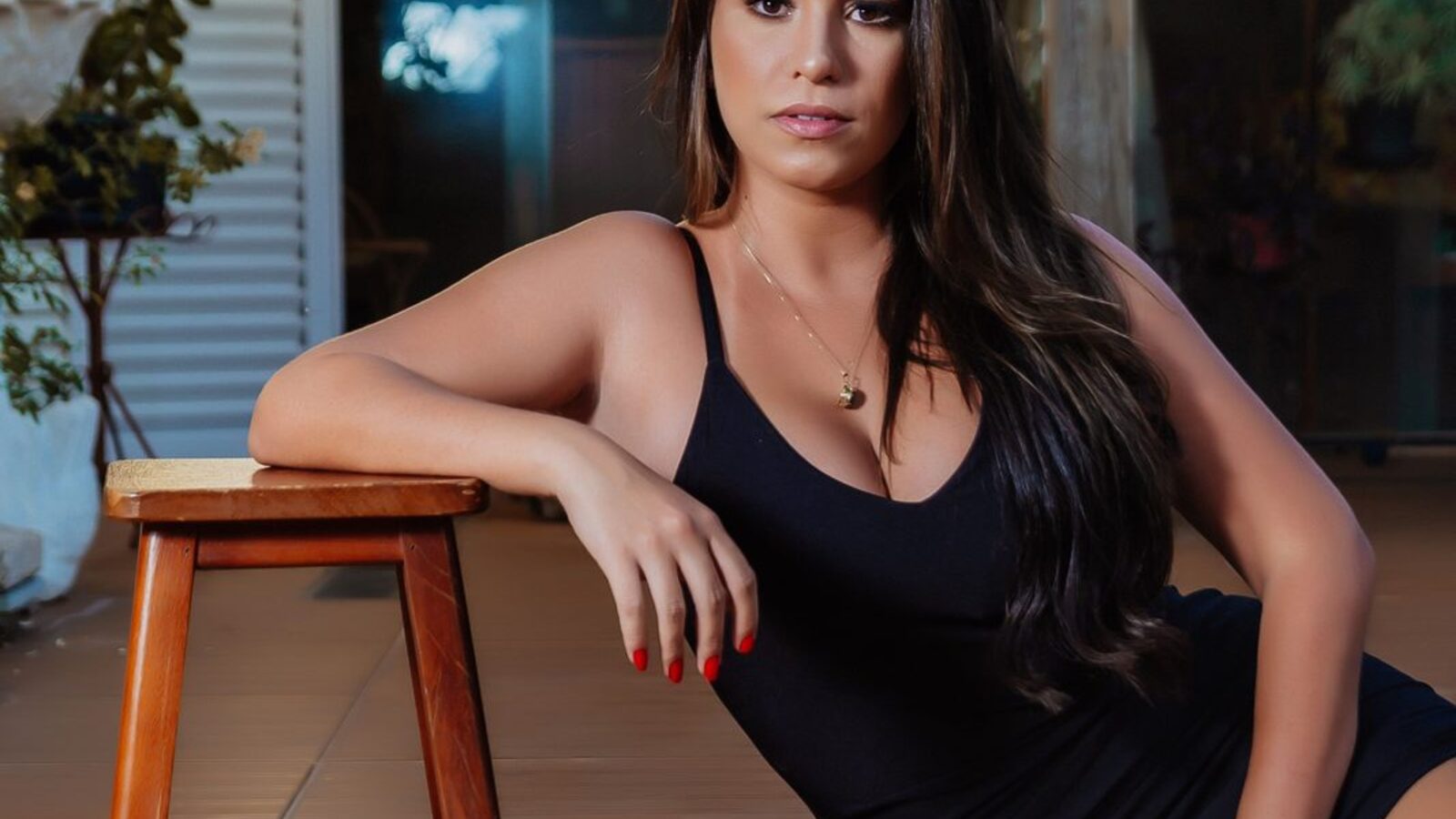 A woman in a black dress on a patio