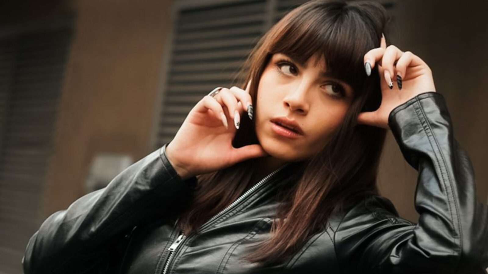A woman in a leather jacket in an urban setting